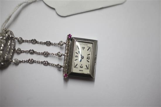 A 1920s rose cut diamond and ruby set staybrite steel Le Coultre lapel watch with diamond set suspension brooch, 55mm.